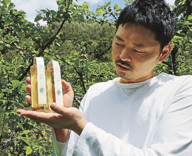 有本農園が製造した翠香のシロップと有本陽平さん（和歌山県みなべ町東岩代で）