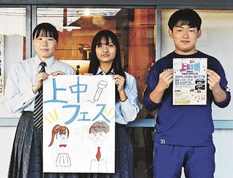 イベントのチラシと手作りのポスターを持つ、上富田中３年のボランティアの生徒